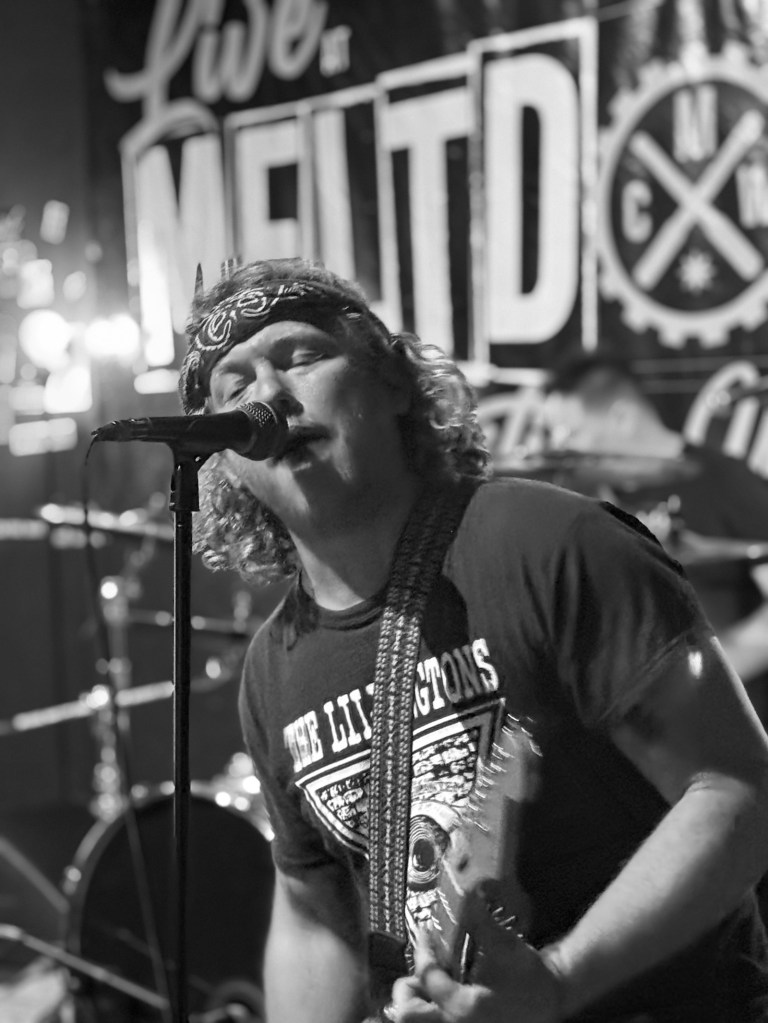a member of the band flamingo nosebleed performing in bloomington illinois